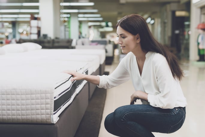 Woman choosing a mattress in store