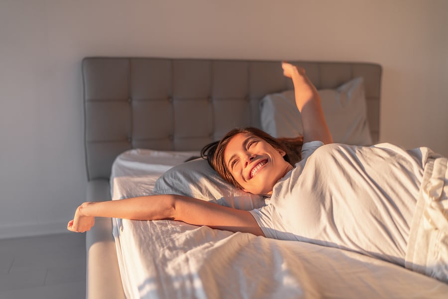 bigstock-Happy-girl-waking-up-in-the-mo-288944401