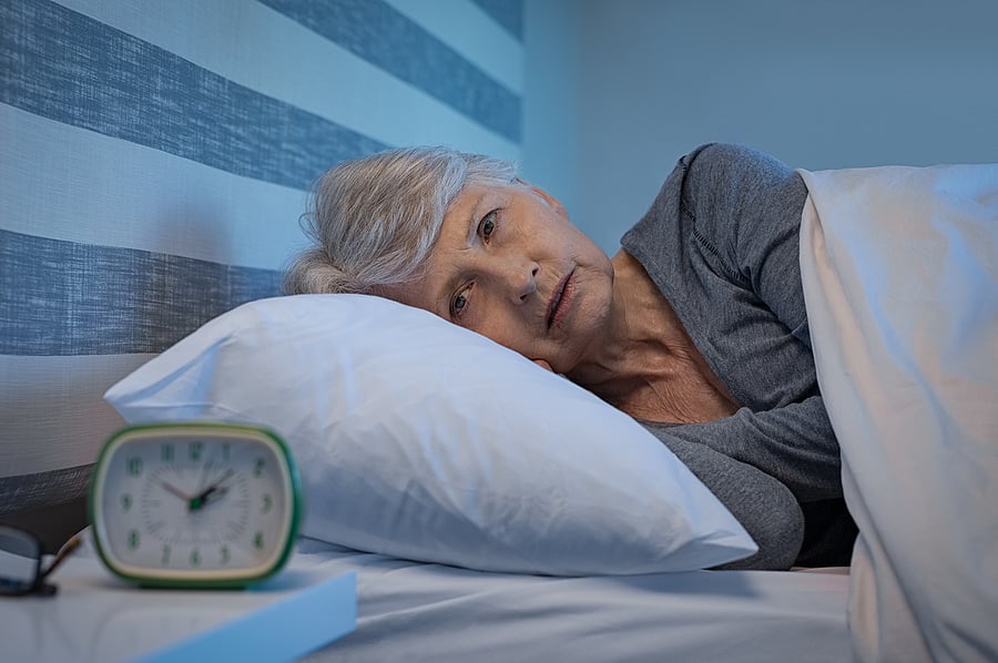 bigstock-Worried-senior-woman-in-bed-at-257179510