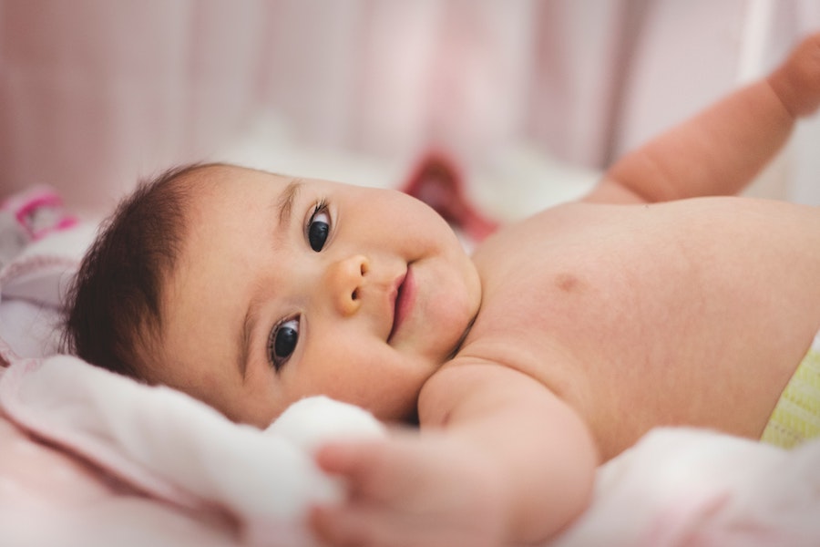 baby ready for bed smiling in sheets-1